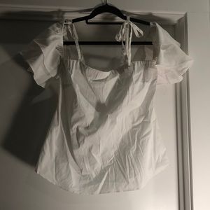 Pretty white blouse with sleeves that sit on upper arm with ties at the top